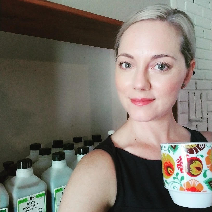 Amanda holding colorful coffee cup.